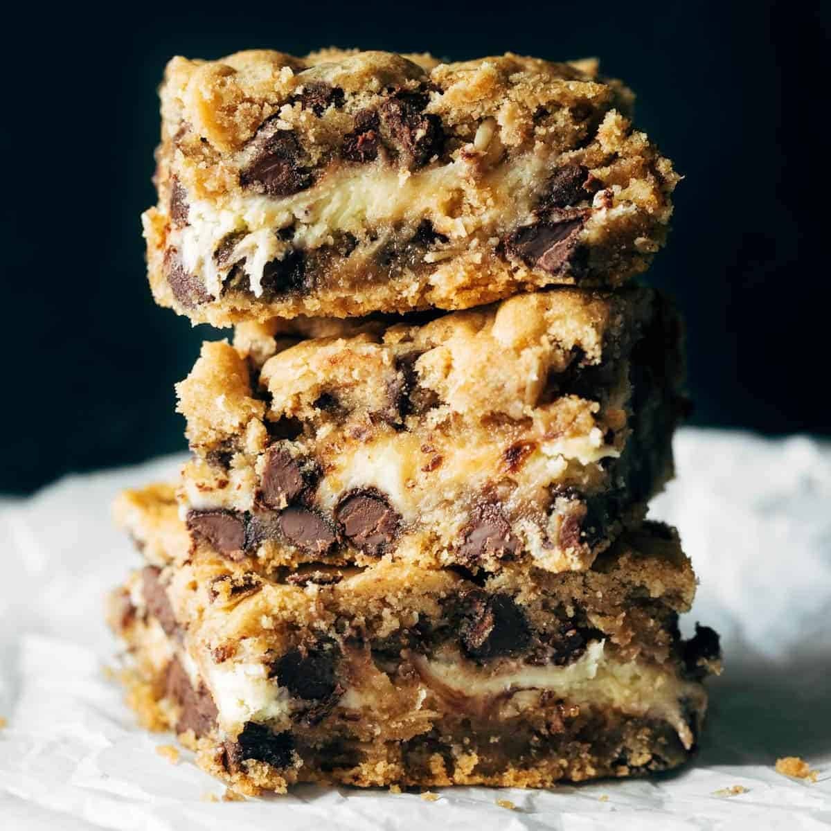 Stacks of chocolate chip cookie cheesecake brownies.