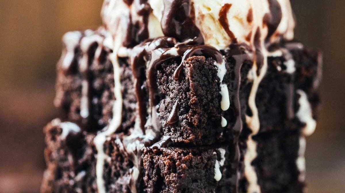 Extra Fudgy Coconut Oil Brownies on a plate with ice cream.